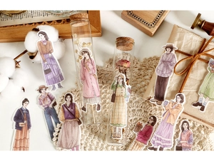 Detailed view of vintage girl character stickers for journaling on white lace decor