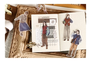 Artistic detail of character stickers for planners in a vintage aesthetic setting