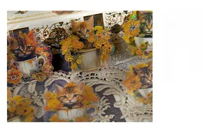 Detailed view of cat stickers with holographic finish on vintage paper and white lace