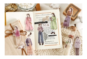 Detail showing vintage Japanese character stickers on grid paper with floral accents