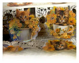 Close-up of cat-themed PET stickers with gold foil details on a vintage background