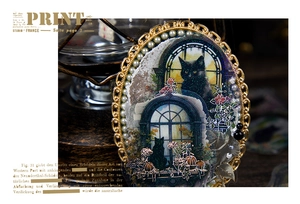 Detailed view of vintage black cat sticker with gold ornate frame and pearl accents