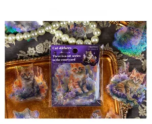 Macro shot of 45pcs laser cat stickers set in a vintage gold tray with lace and pearls
