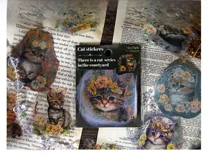 Close-up of cat-themed PET stickers with gold foil details on a vintage book page