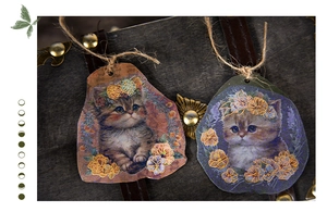 Detailed view of hand-drawn cat themed craft tags with twine on a vintage wooden box