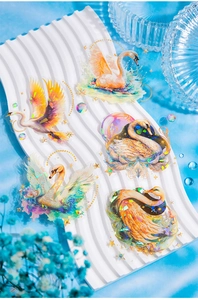 Close-up of holographic laser swan stickers with shimmering iridescent PET material