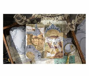 Vintage scrapbooking paper set with balloon and lace motifs on a rustic wooden tray