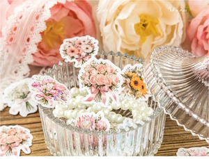 Detail of floral stickers with roses and sunflowers among decorative pearls