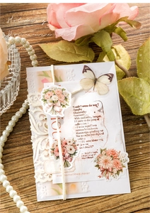Detailed view of floral scrapbooking stickers with vintage motifs and butterfly accents