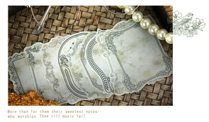 Close-up of vintage decorative labels with European ornate borders on a woven tray