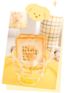 Detail of toast-shaped sticky notes with motivational quotes in a glass bowl