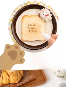 Cute toast-shaped sticky notes with paw prints and a cartoon dog clip on a warm table