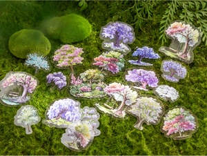 Translucent PET tree stickers with forest themes scattered on natural green moss background