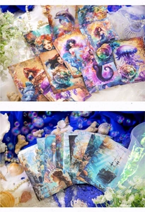 Detail of Undersea Dream scrapbooking paper with iridescent mermaid and dolphin motifs