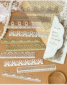 Detailed macro shot of vintage hollow lace paper strips for scrapbooking decoration