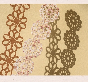 Detail of vintage hollow lace paper with intricate floral patterns for DIY scrapbooking