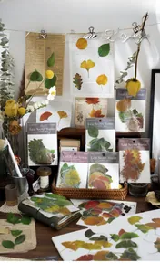 Artistic detail of vintage PET leaf stickers on retro newspaper and wood background