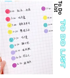 Translucent colorful dot stickers applied to a grid notebook for schedule planning