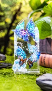 Macro detail of Fairy Wings acrylic butterfly ornament with pearls on green moss base