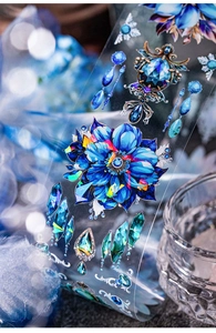 Macro shot of blue floral PET tape with sparkling gemstone patterns for scrapbooking