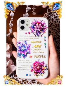 Macro detail of white iPhone case with floral stickers and vintage English typography