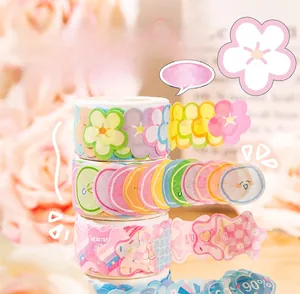 Close-up of pastel floral washi tape and die-cut stickers for DIY scrapbooking decor