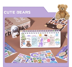 Close-up of cute bear stickers and spiral notebook with aesthetic DIY collage details