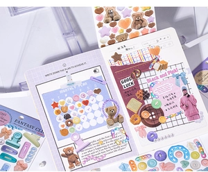Detailed aesthetic setup featuring cute bear stickers, bread motifs, and pastel binder clips