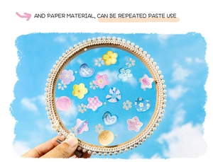 Close-up of decorative DIY sticker frame with white pearls against a blue sky background