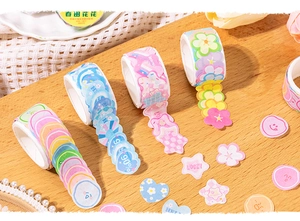 Detail view of colorful die-cut scrapbooking tape with flower and heart shapes