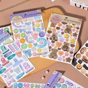 DIY decorative sticker set with bear and vintage button patterns on a wooden tray