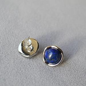 Detail of round lapis lazuli stud earrings with 925 silver pin and silicone backing