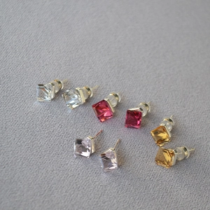 Close-up of geometric square crystal earrings in multiple colors with 925 silver needles