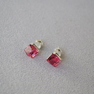 Macro shot of cubic rose pink crystal studs with silver 925 needles and silicone backs
