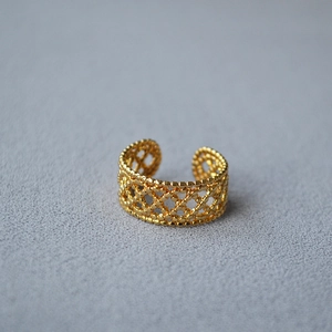 Exquisite gold open ring with intricate hollow lace mesh pattern in a minimalist style