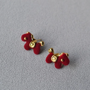 Festive red flocked puppy dog stud earrings with gold accents and silver needle posts
