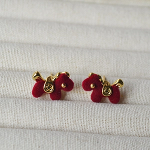 Cute red flocked puppy stud earrings with gold coin details in a jewelry gift box