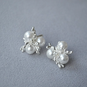 Macro detail of French vintage silver stud earrings with cluster pearl firework design
