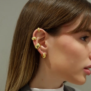 Close-up of gold-plated water drop earrings and minimalist ear cuffs set on model