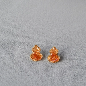 Gourd-shaped amber glass earrings with gold beaded frames and crystal pavé details