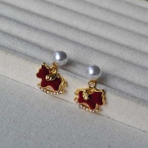 Close-up of red flocked rocking horse earrings with imitation pearl and 925 silver studs