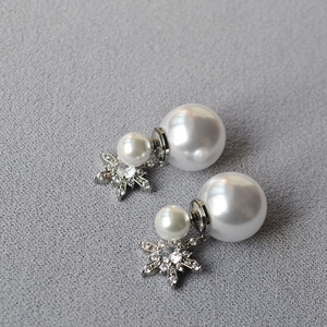 Elegant snowflake tassel double pearl earrings with crystal inlay on a grey fabric background