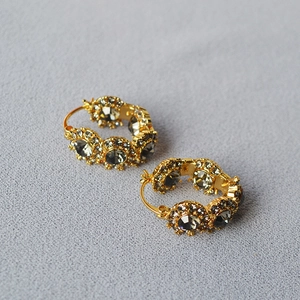 Vintage hoop earrings in gold brass featuring smoky grey crystals and floral petal details
