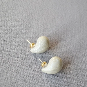 Macro view of cream marble teardrop earrings with gold-tone hardware and 925 silver pins