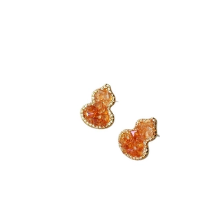 Elegant gold-tone gourd earrings with gradient orange crystal and sparkly pavé diamonds