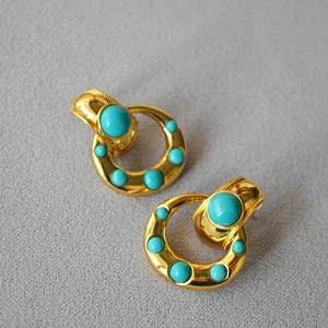 Vintage brass gold plated hoop earrings with turquoise beads in a minimalist design