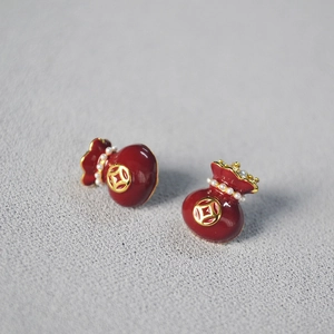 Detail of red enamel fortune bag earrings with gold coin motif and mini pearls