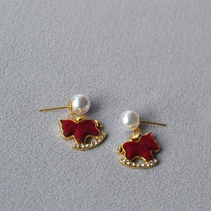 Detail of red flocked rocking horse earrings with white pearl and sparkling crystals