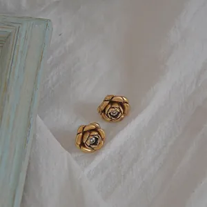 Vintage 3D carved rose stud earrings in antique gold finish with sparkling cubic zirconia