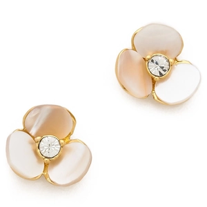 Macro shot of white shell clover earrings with golden edges and centered crystals